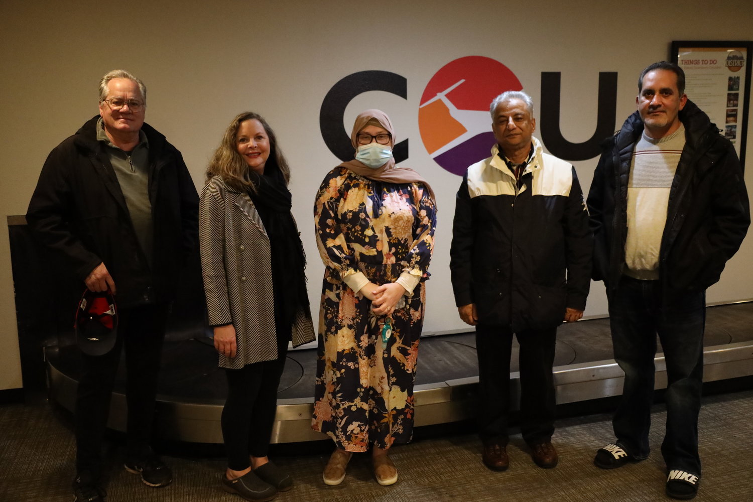 Members of the Catholic Charities ecumenical Community Sponsorship group awaits refugee arrivals at Columbia Regional Airport.